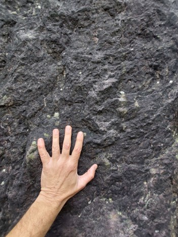 bare hand, wrist, forearm resting on rockface